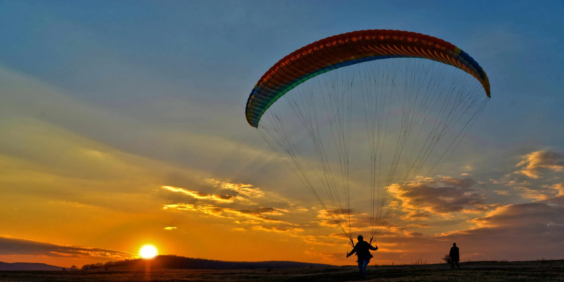 Paraglider launching at sunset above Jounieh Bay, Lebanon