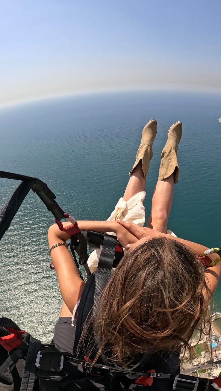 Passenger's view of the turquoise sea while paragliding over Lebanon