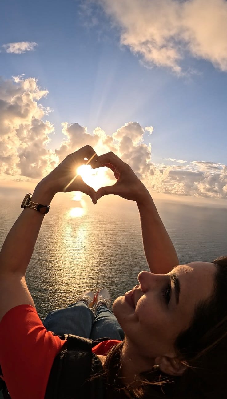 Sunset heart-hands photo taken during a paragliding flight in Lebanon